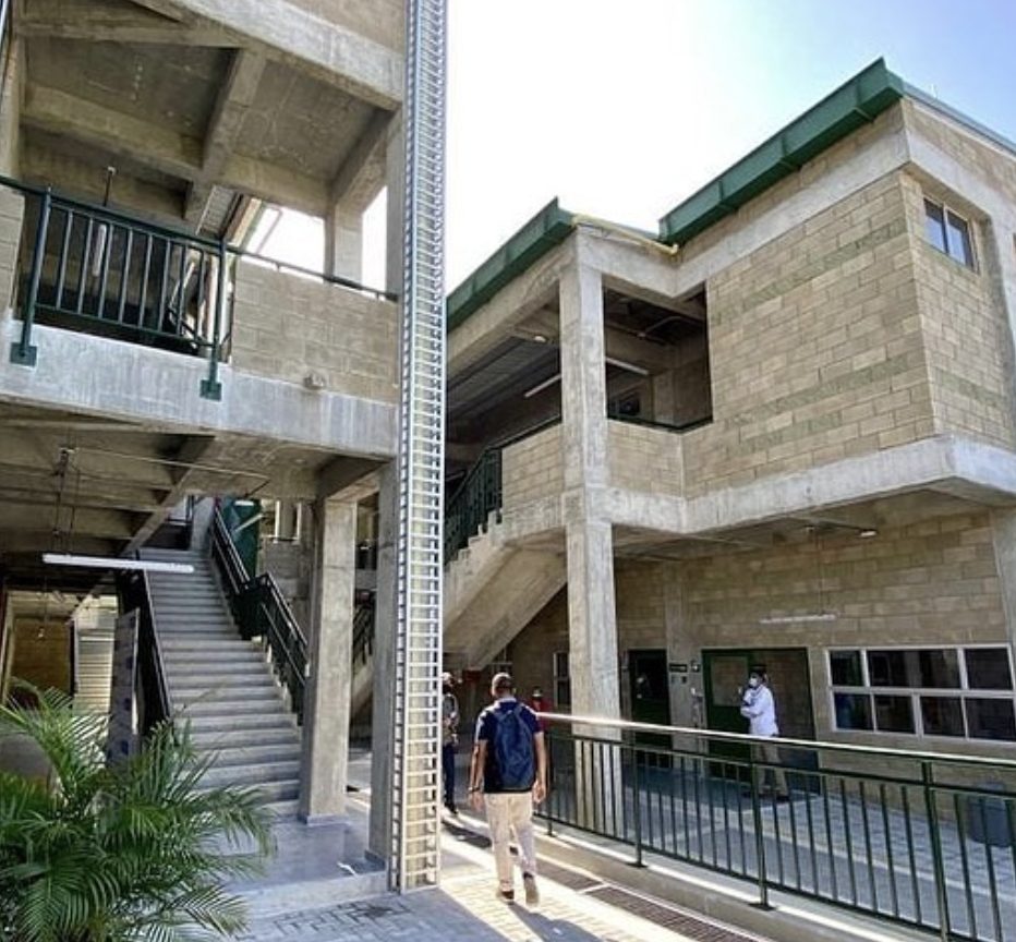 Patio interior de megacolegio con muros en bloque de concreto a la vista Tectónico